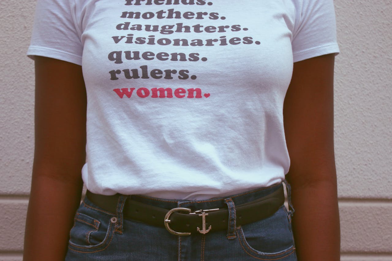The Art of Drawing Readers In: Your attractive post title goes here Close-up of a t-shirt celebrating womens roles and empowerment.
